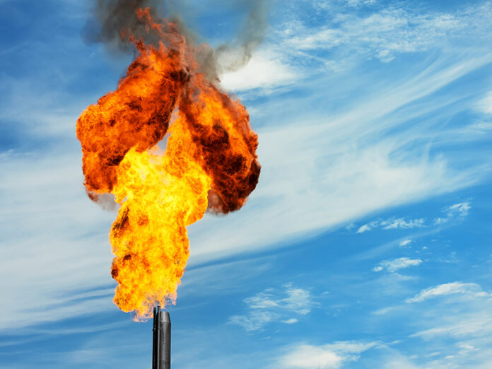 Gas flaring. Torch against the sky.