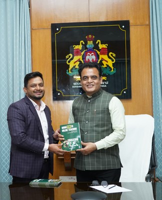 Mr Christo Joseph launches his book 'Bring Fun To Online Mr Christo Joseph presenting the book to Dr C. N. Ashwath Narayan