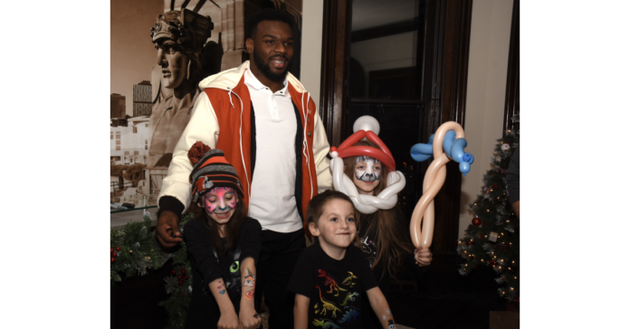 Local Law Firm Hosts Holiday Party for Cuyahoga County Youth with Browns Player